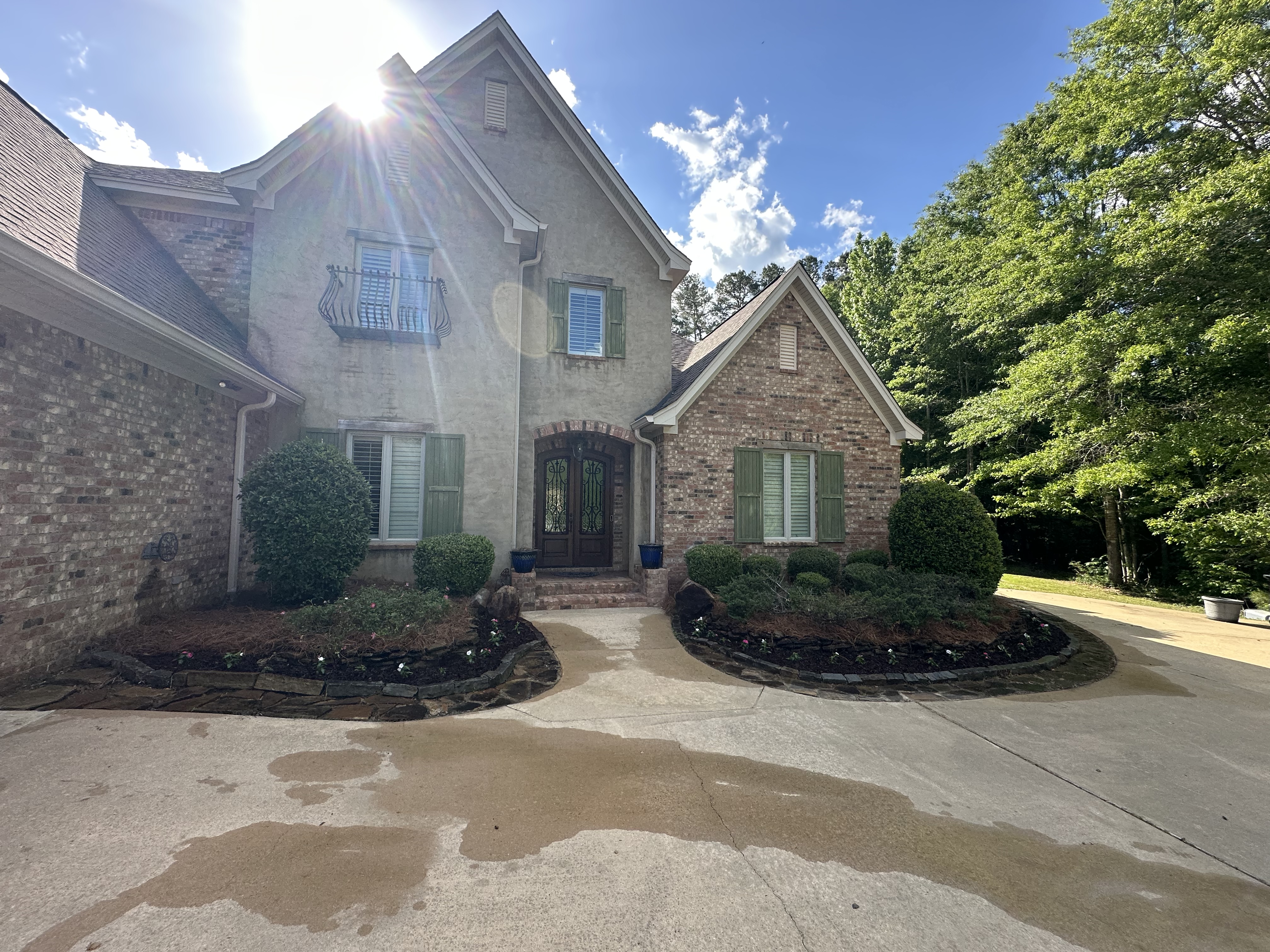 Freshly washed driveway at a brick home